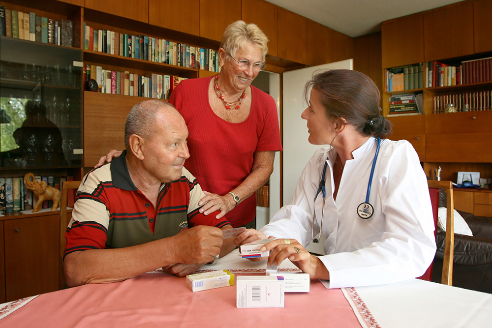 General practitioner visiting patient at home